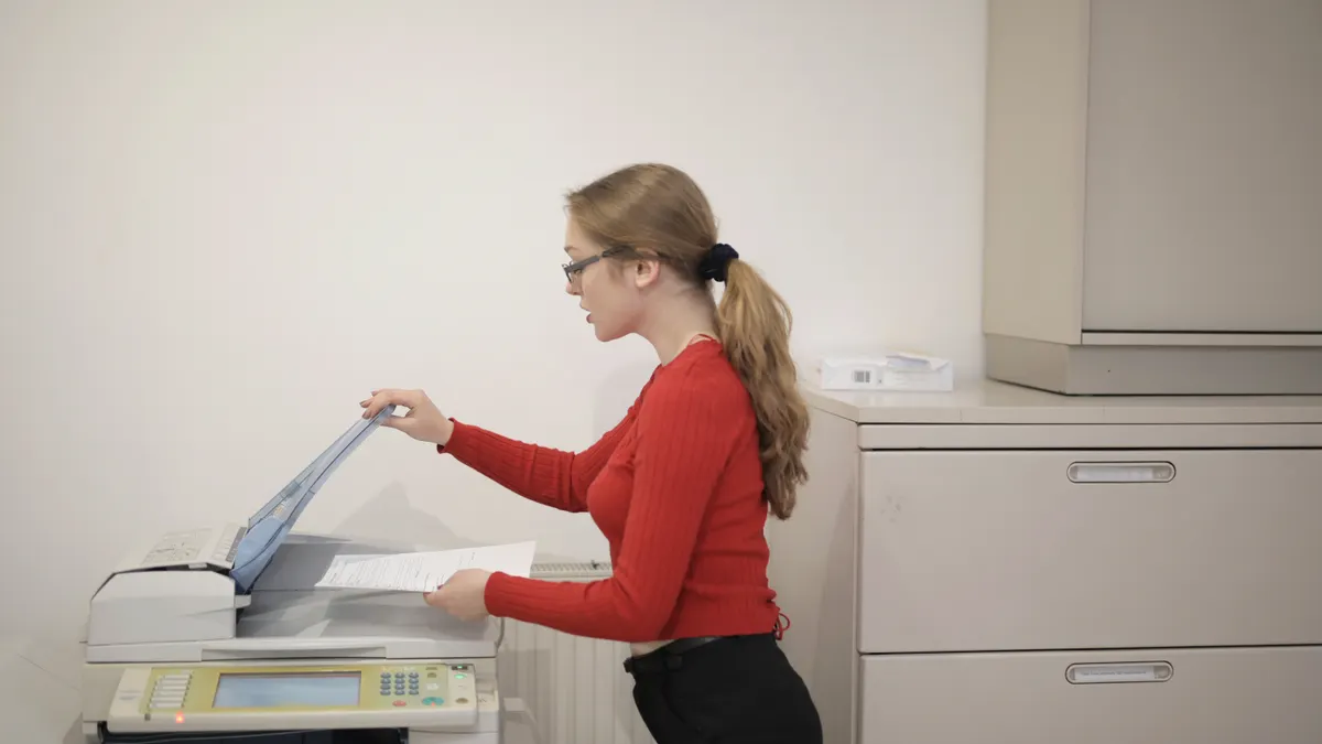 Woman using a printer copier