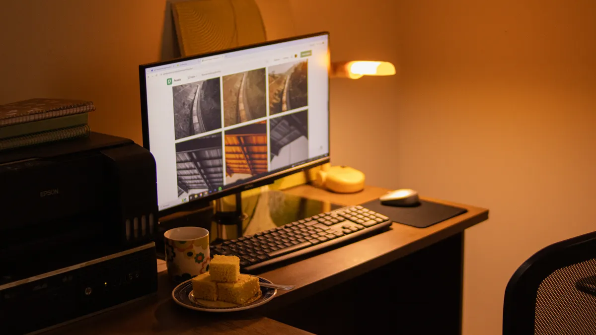 Desk with computer and printer in warm lighting