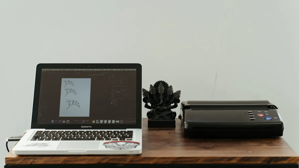 Printer setup, installation, and first-time use — The Complete Guide Laptop beside a small printer on a table